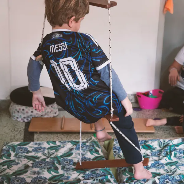 Niño jugando en la hamaca de soga